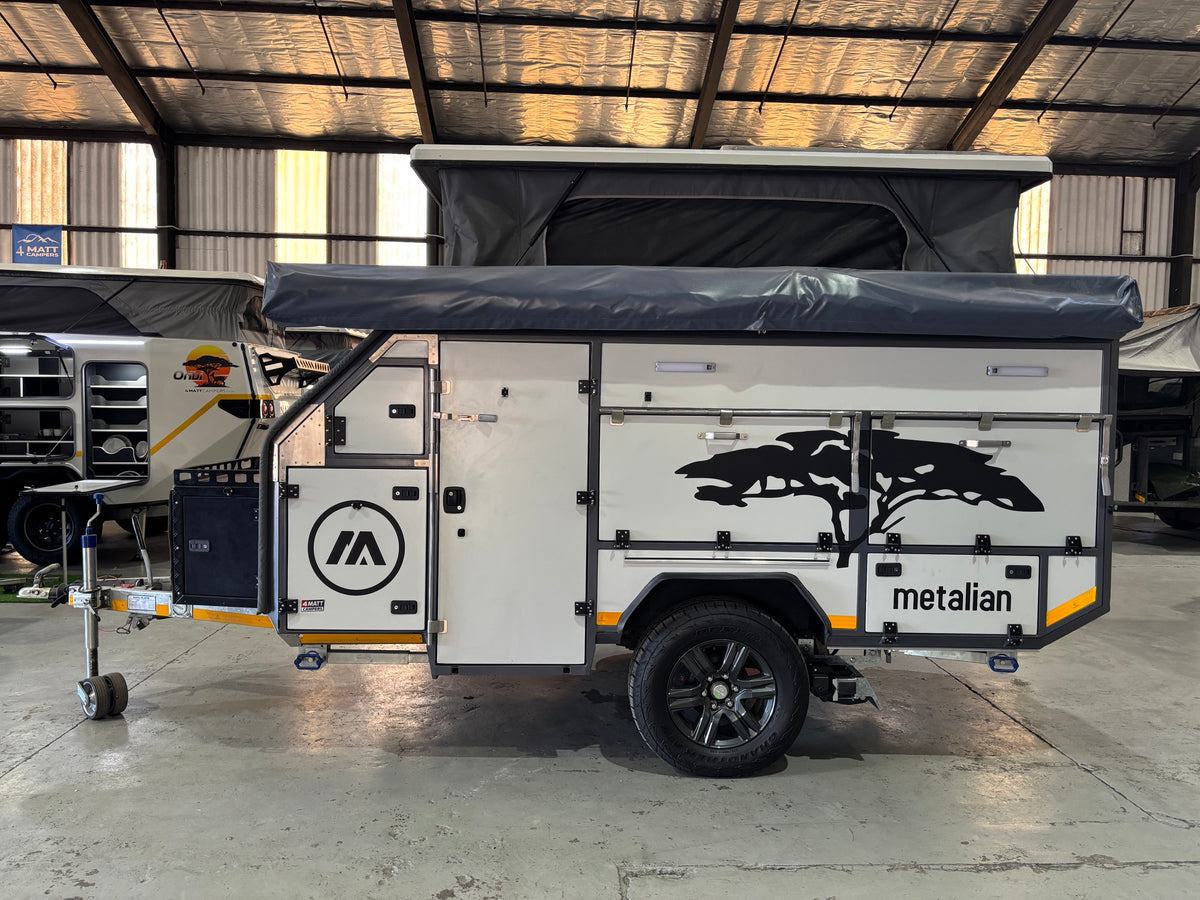 Metalian M42 off-road caravan, pop-top roof raised, side profile