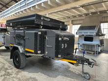 2025 Metalian Maxi off-road camping trailer in charcoal, front three-quarter view with the rooftop tent closed