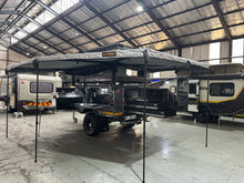 Metalian Maxi set up in camp mode with the awning out and the kitchen and rear drawers open