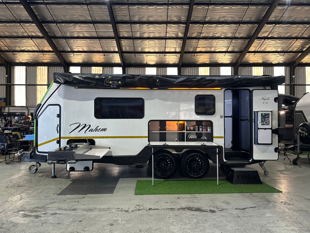 2026 Nayela Mahem demo – side view with 360 awning and slide-out outside kitchen deployed