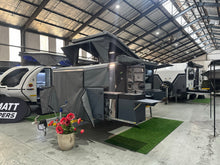 Silverback Lunar off-road camper, side view with the awning out and the galley doors open