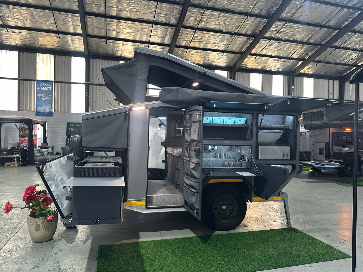 Silverback Lunar off-road camper, side view with the roof raised, the side galley open and the front kitchen box pulled out