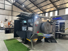 Silverback Lunar off-road camper, rear view with the spare wheel and open storage lockers