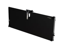 Universal tailgate table folded against a panel