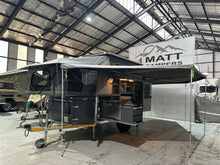 2025 Tuff Cats Shumba Elite 2 – front three-quarter view set up at camp with the 270° awning out and kitchen open