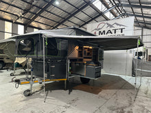2025 Tuff Cats Shumba Elite 2 – three-quarter view with the front fold-out bed, raised roof and awning deployed